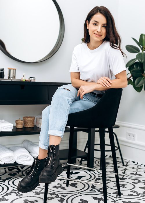 vertical-view-of-the-hairstylist-sitting-with-arms-crossed-in-her-salon.jpg